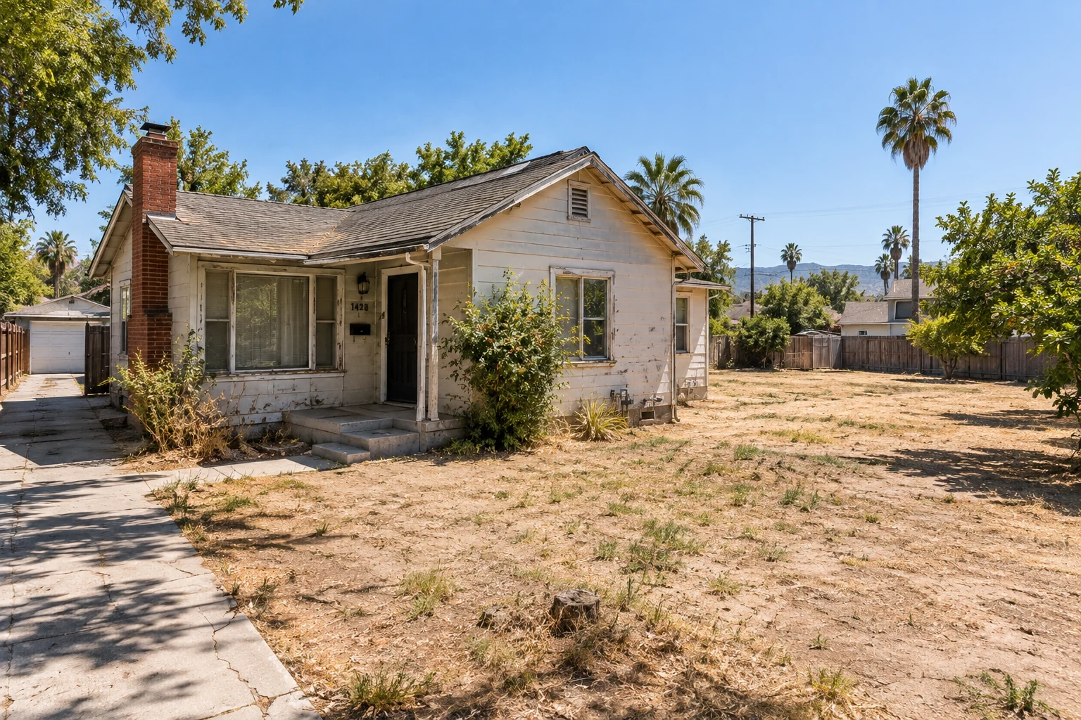 Before concept: an older California house with an open yard beside it